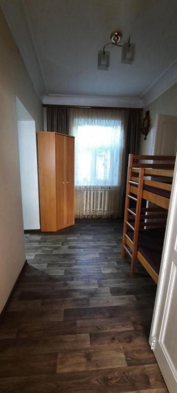 an empty room with a bunk bed and a window at Гостевой дом in Odesa