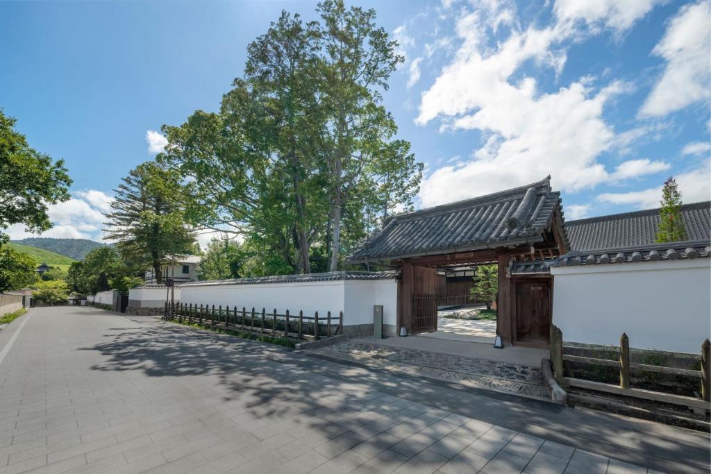 a road leading to a building with a fence at Shisui, a Luxury Collection Hotel, Nara in Nara