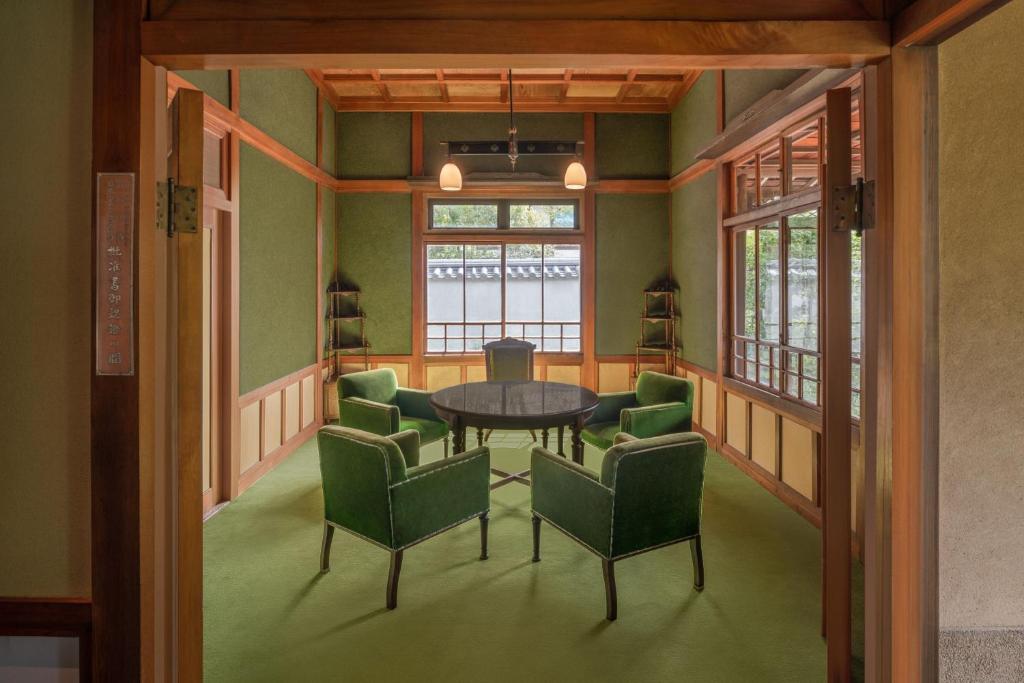 a dining room with green chairs and a table at Shisui, a Luxury Collection Hotel, Nara in Nara