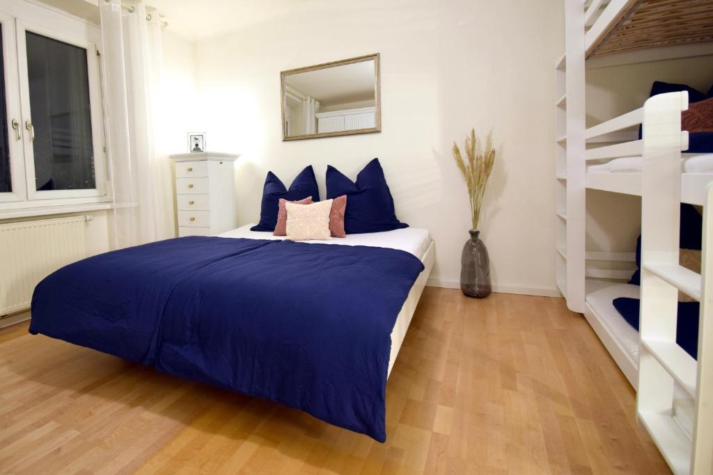 a bedroom with a blue and white bed and bunk beds at “Opera House” Apartment Graz - Self Check-In in Graz
