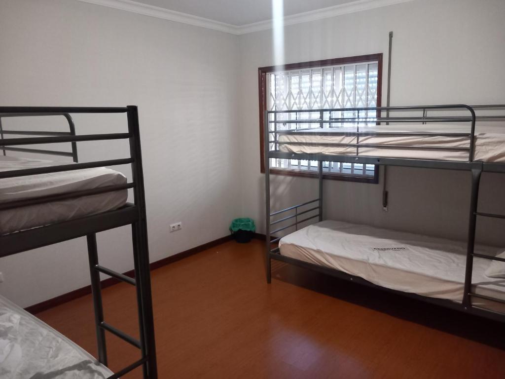 a room with three bunk beds in a room at PRIME ALOJAMNETOS 01 in Gondomar