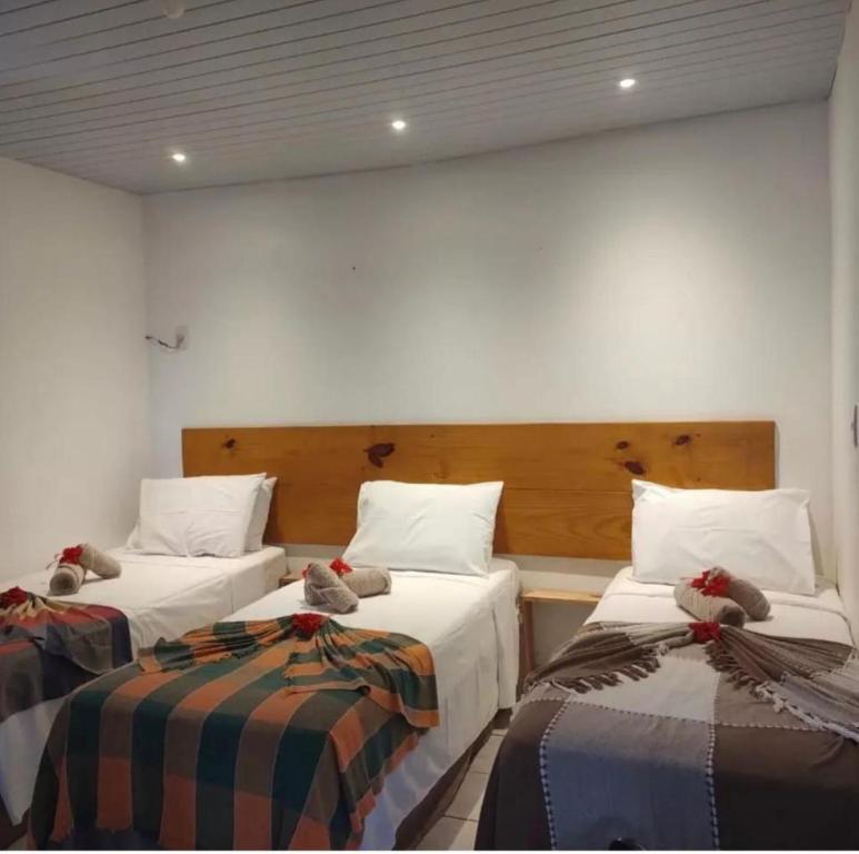 Un pat sau paturi într-o cameră la Pousada Guedes Noronha