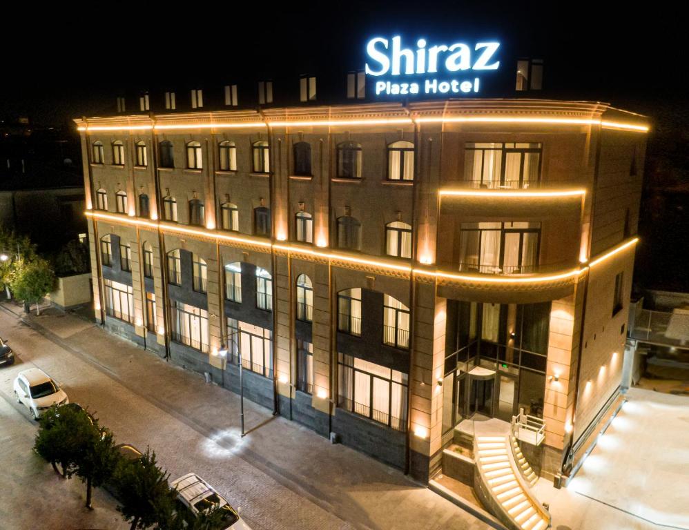 un gran edificio con un cartel encima en Shiraz Plaza Hotel & Spa en Gyumri