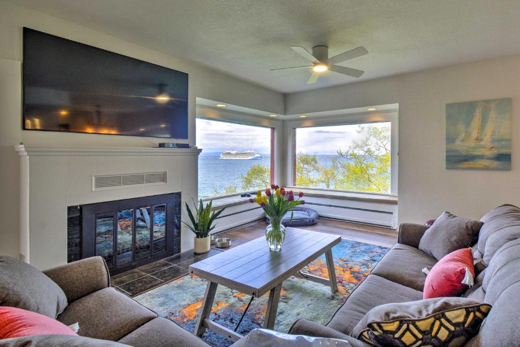 a living room with a couch and a fireplace at Chic Port Angeles Home with Oceanfront Balcony! in Port Angeles