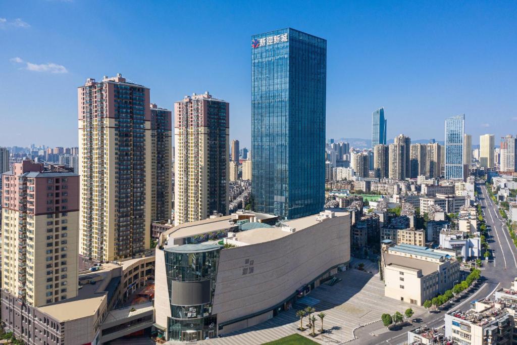 an aerial view of a city with tall buildings at Fairfield by Marriott Kunming Xinying in Kunming
