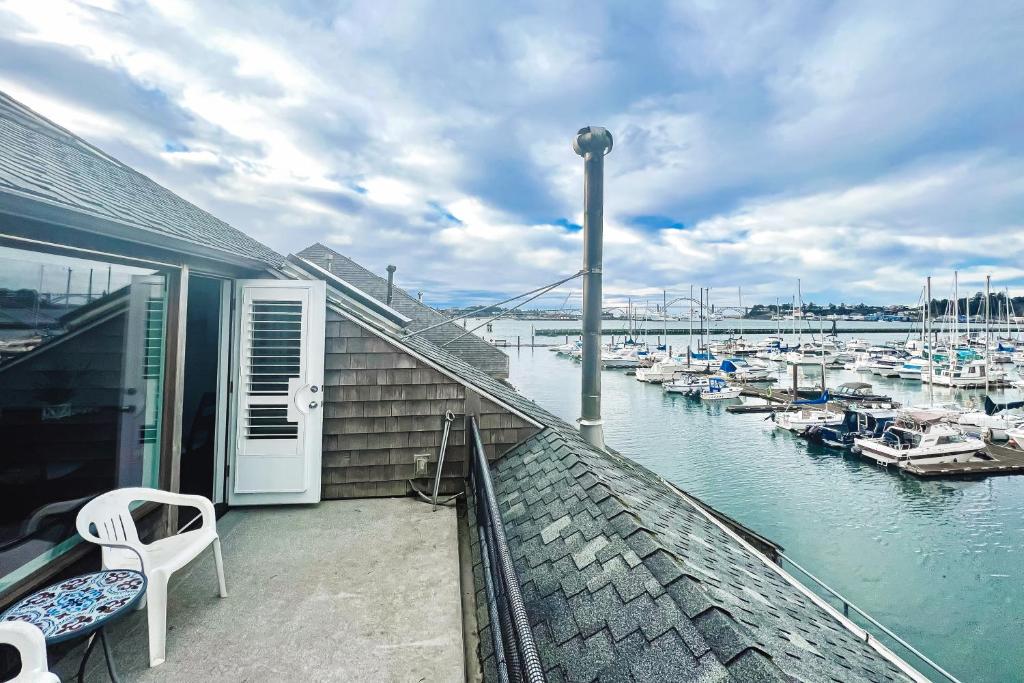 a balcony with a view of a marina with boats at Down By The Bay #C202 in Newport