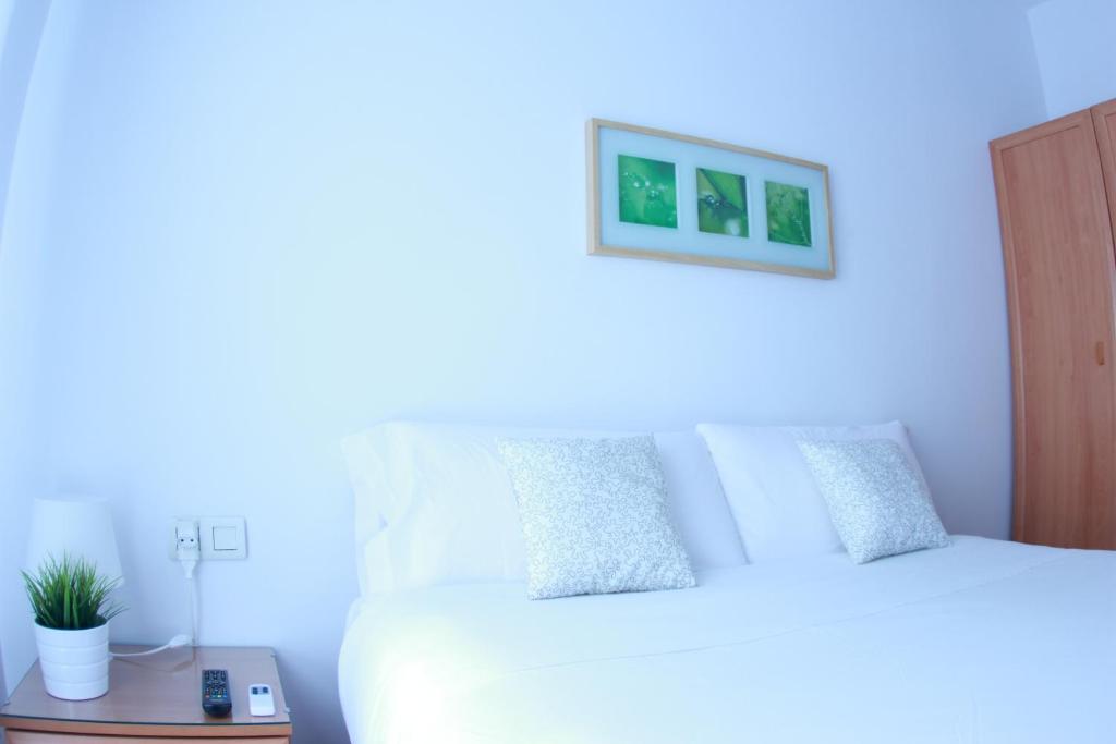 Кровать или кровати в номере Zubia Urban Rooms