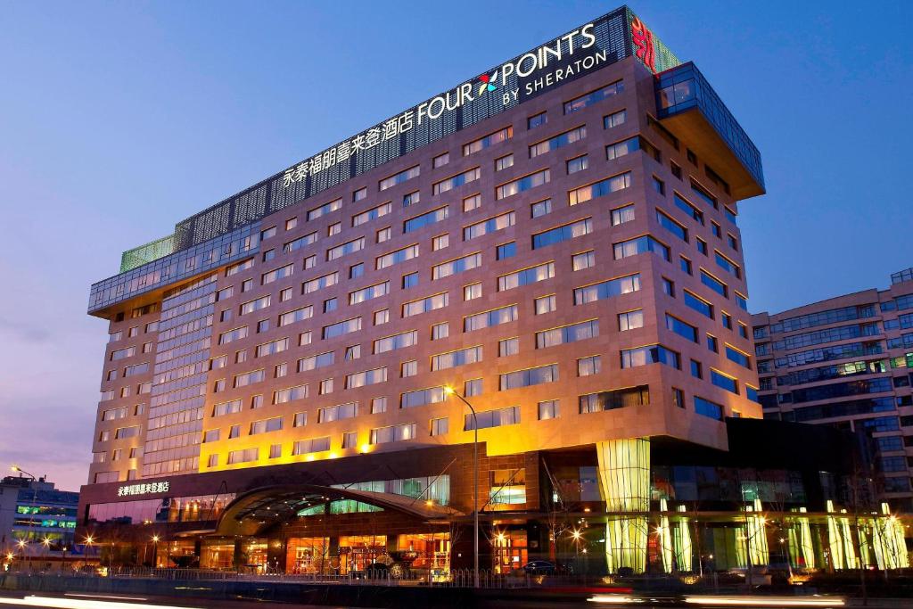a hotel building with a sign on top of it at Four Points By Sheraton Beijing, Haidian in Beijing