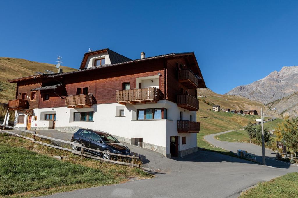 a house with a car parked in front of it at Apartment Il Nocciolo in Livigno