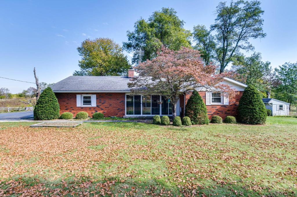 a red brick house with a large yard at Quaint Economy Retreat with Patio and Spacious Yard! 