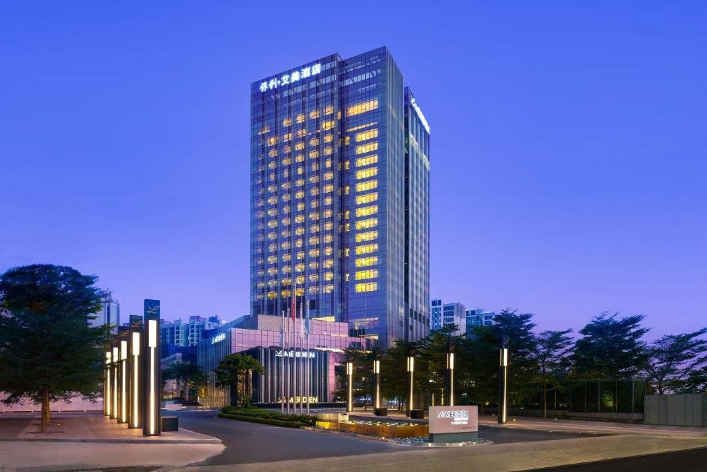 a tall building with lights in front of it at Le Meridien Zhongshan in Zhongshan