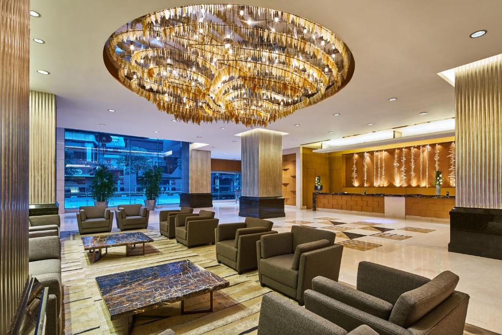 a lobby with chairs and a large chandelier at Four Points by Sheraton Shanghai, Daning in Shanghai