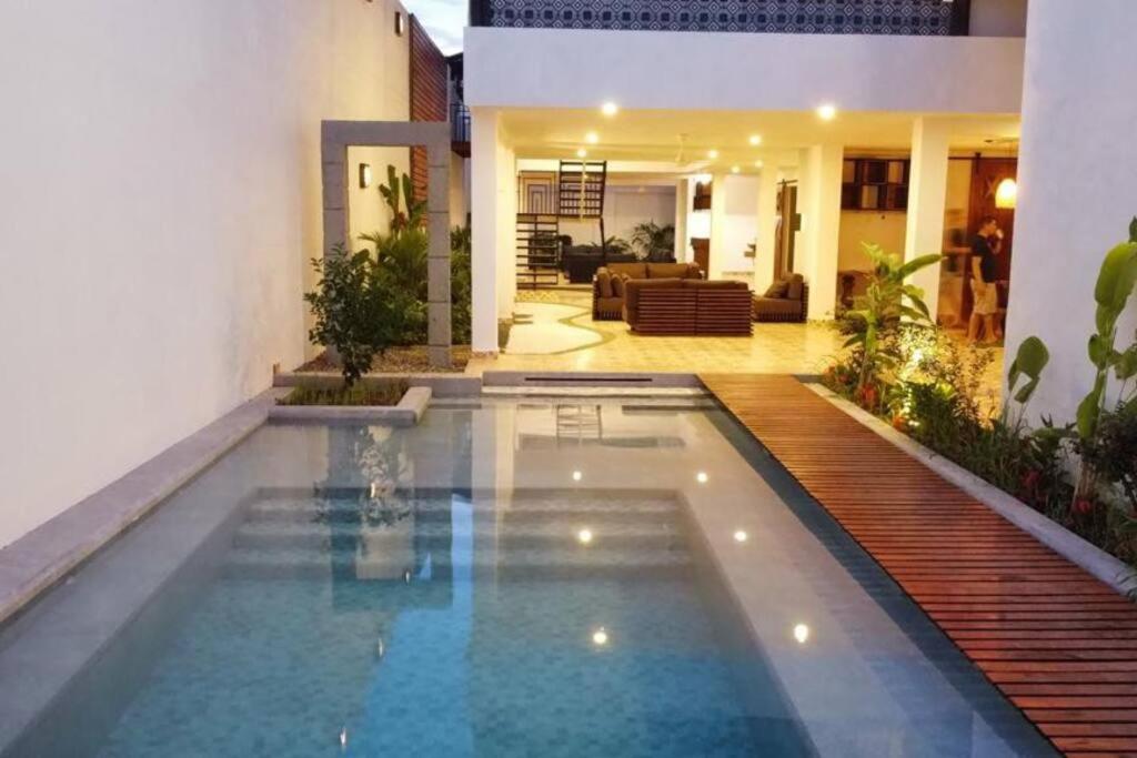 a swimming pool in the middle of a house at Casa Amarilla in Honda