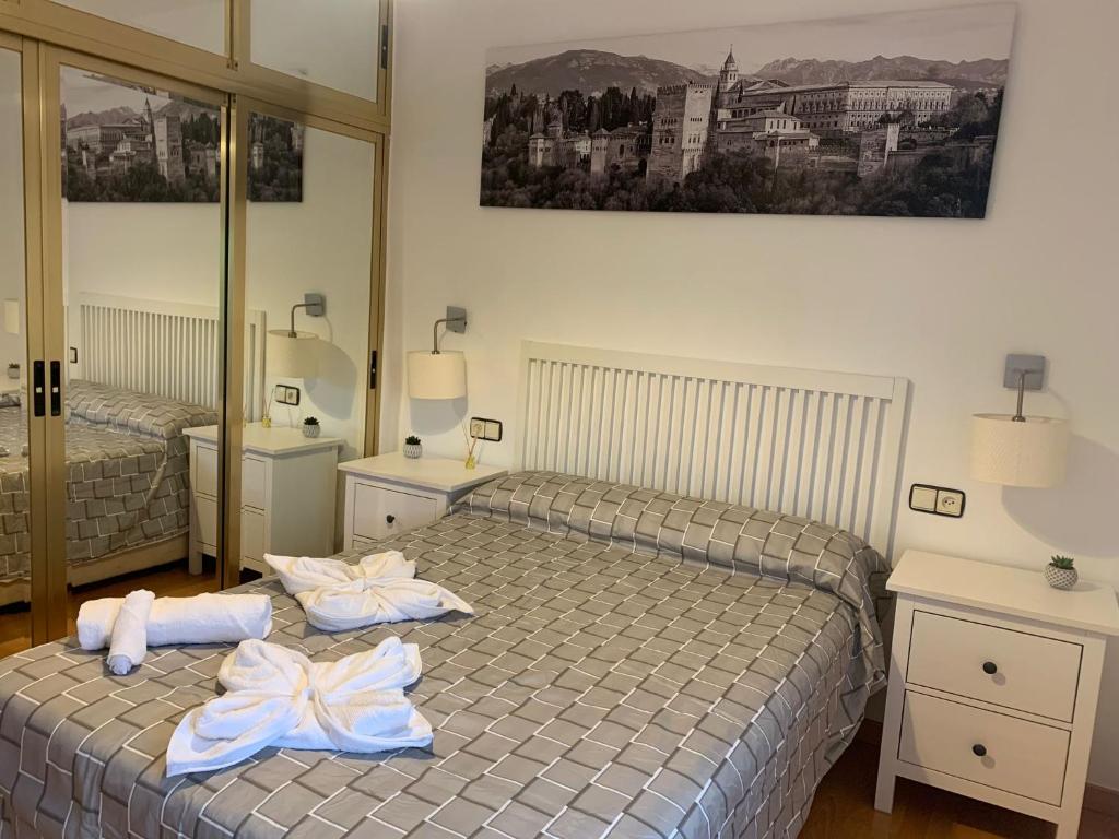 a bedroom with two beds with towels on them at APARTAMENTO GOR in Granada