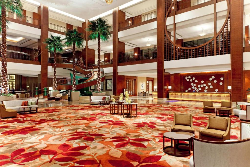 a hotel lobby with a large carpet of flowers at Sheraton Dongguan Hotel in Dongguan