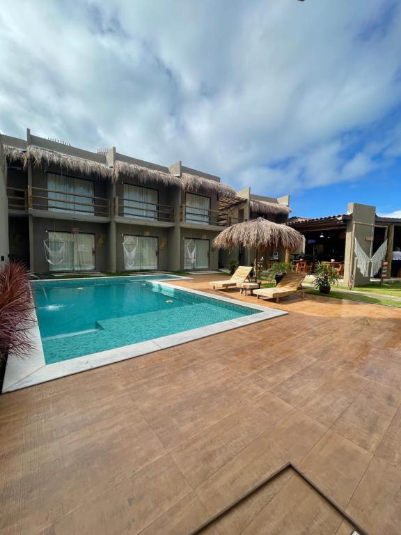 an image of a house with a swimming pool at Nauru chalés milagres in São Miguel dos Milagres