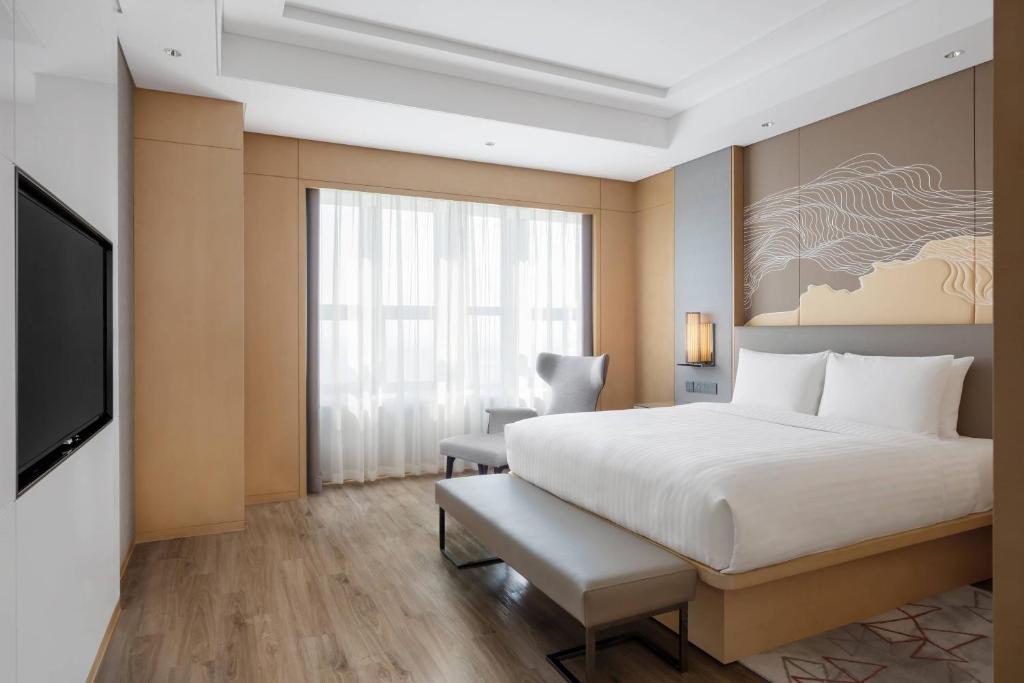 Postel nebo postele na pokoji v ubytování Courtyard by Marriott Shanghai Songjiang