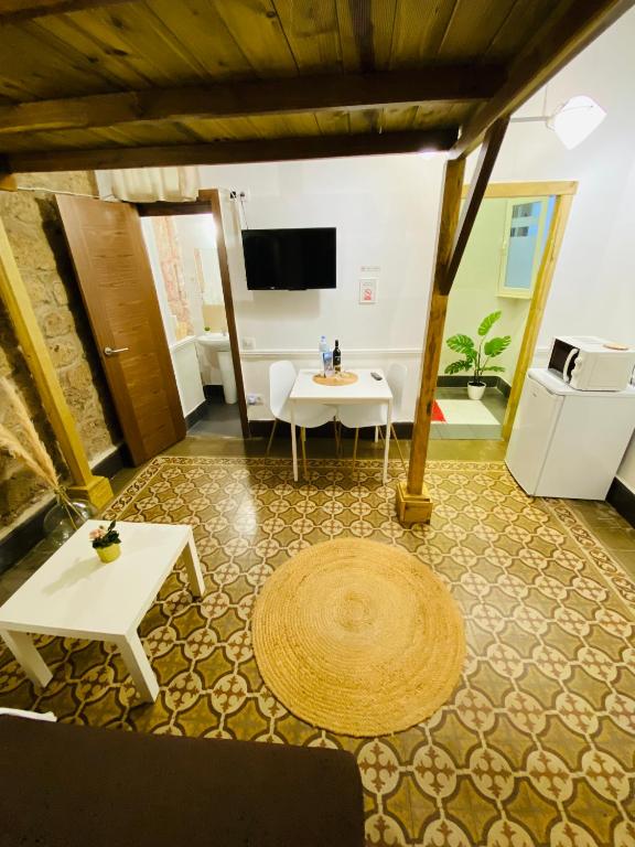 Televízia a/alebo spoločenská miestnosť v ubytovaní Vacacionales Vegueta