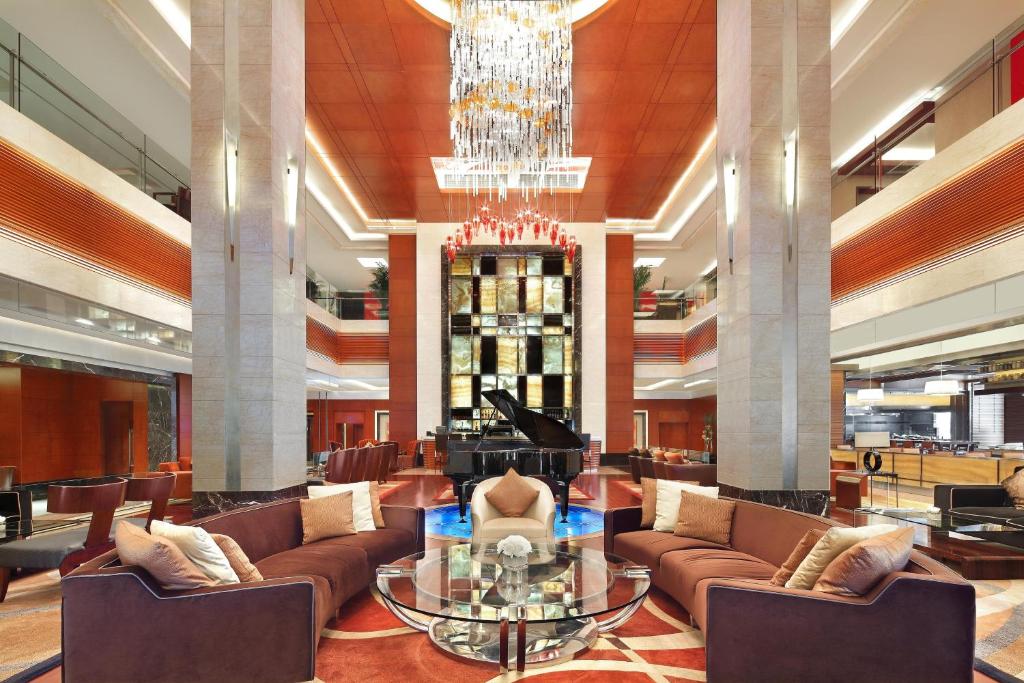 a lobby with couches and a chandelier at Sheraton Wenzhou Hotel in Wenzhou