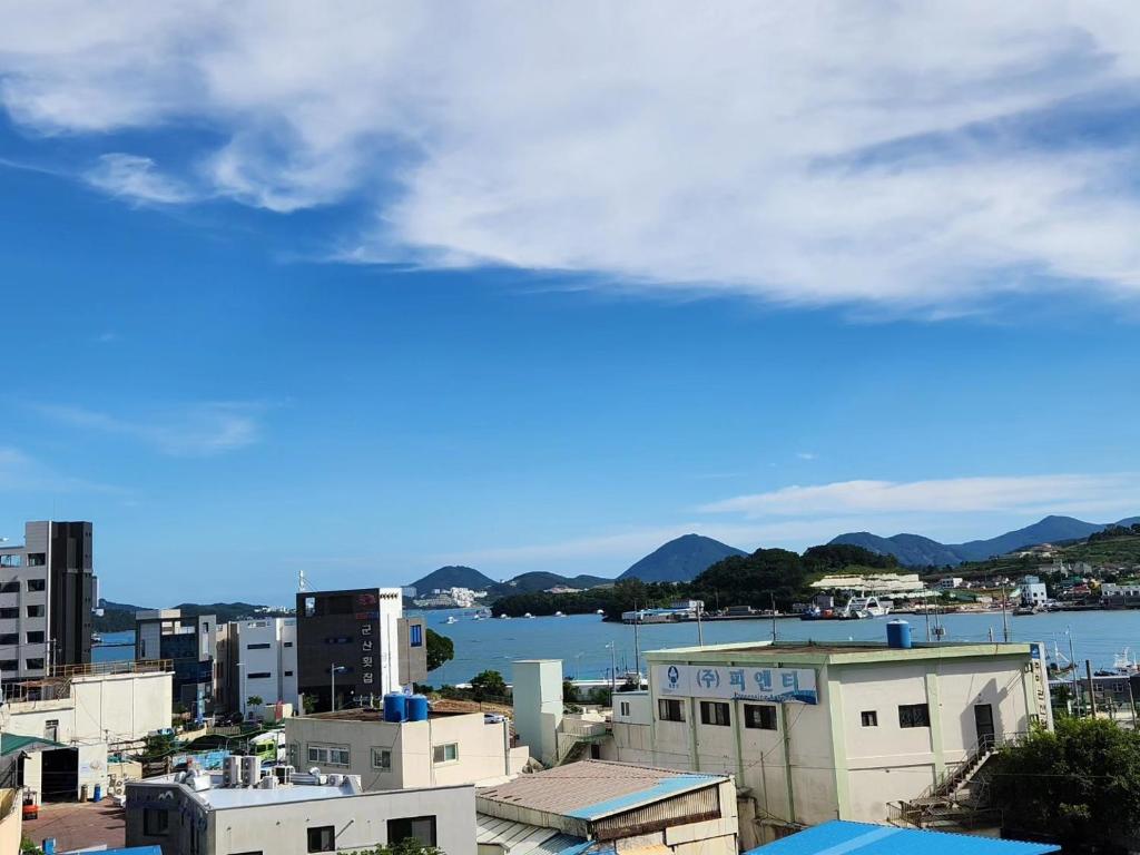 a view of a city with buildings and a body of water at Sim On Chae - one room in Yeosu