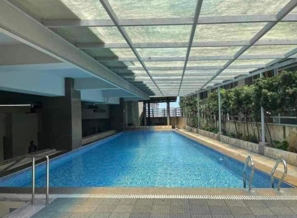 a large swimming pool in a building with a ceiling at Cubic P 1902 in Cebu City