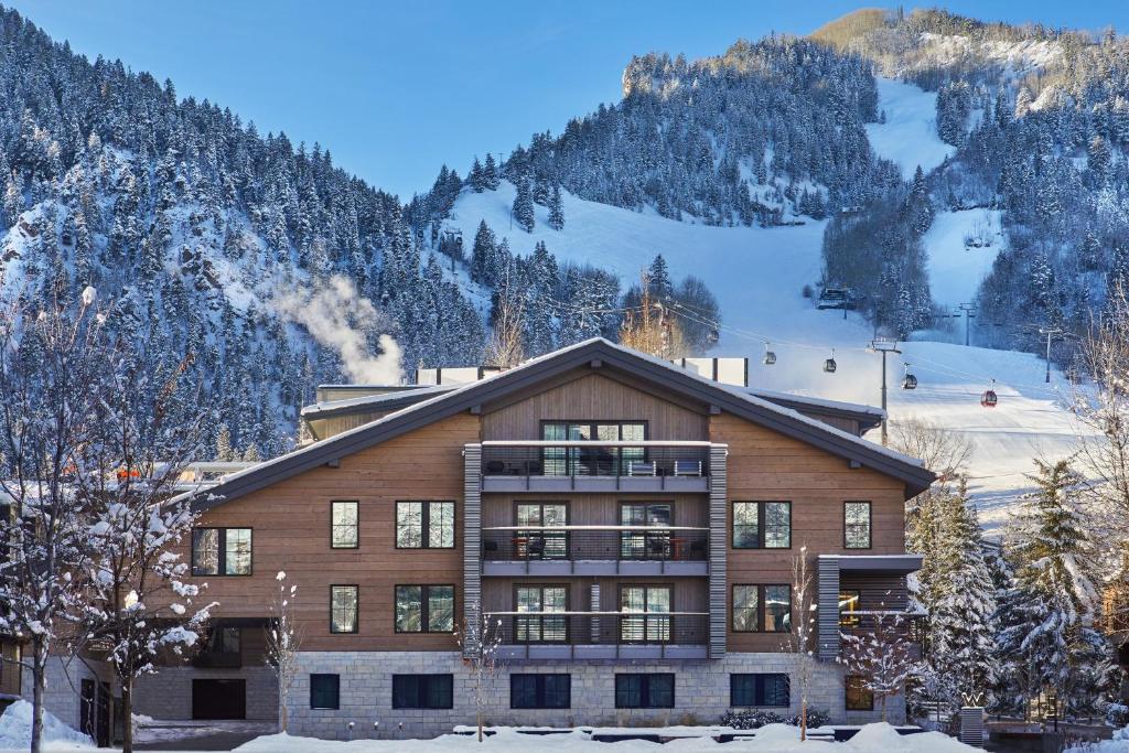 a building in the snow with mountains in the background at W Aspen in Aspen