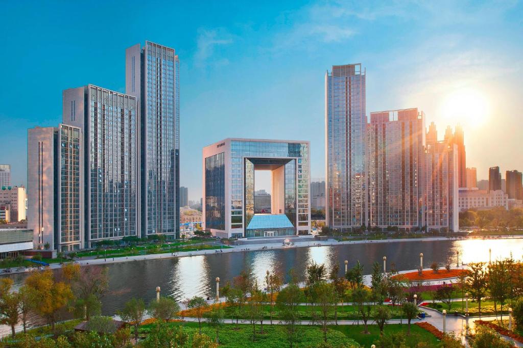 a city skyline with a river and tall buildings at The St. Regis Tianjin in Tianjin