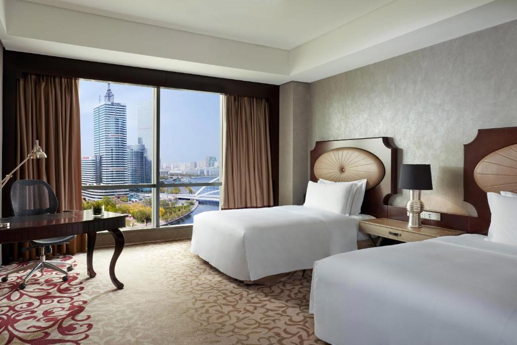 Postel nebo postele na pokoji v ubytování The St. Regis Tianjin