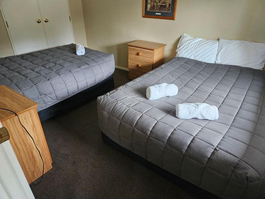 Postel nebo postele na pokoji v ubytování Kiwi Park Motels