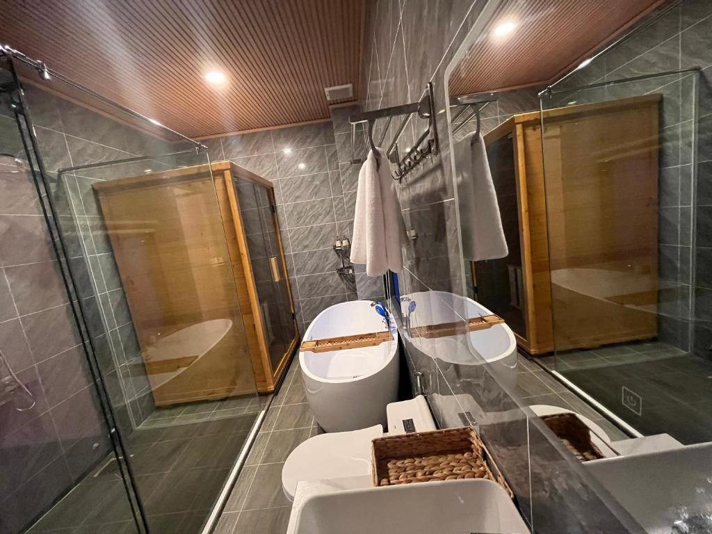 a bathroom with a toilet and a sink and a shower at Homestay Mina House in Long Xuyên