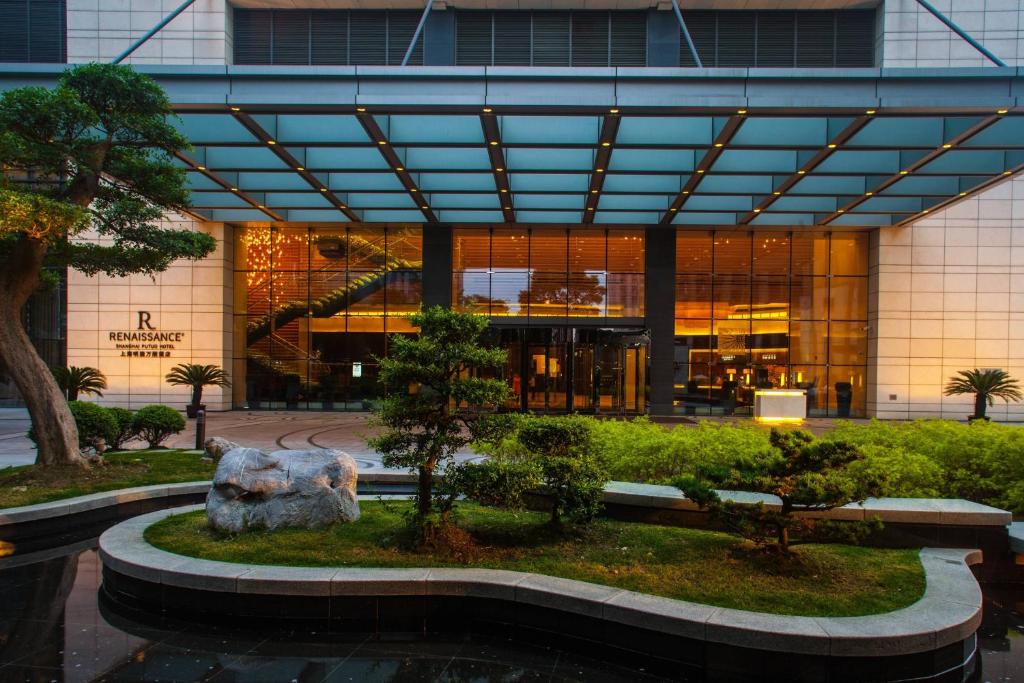 a building with a fountain in front of a building at Renaissance Shanghai Putuo Hotel in Shanghai