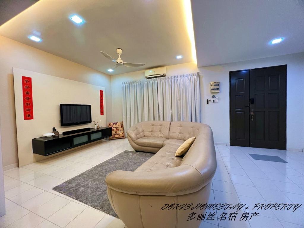 a living room with a couch and a tv at 2 Storey House Bayu Mutiara @ Bukit Mertajam in Bukit Mertajam