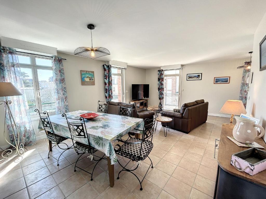 a dining room and living room with a table and chairs at Appartement Saint-Pair-sur-Mer, 3 pièces, 4 personnes - FR-1-361-506 in Saint-Pair-sur-Mer