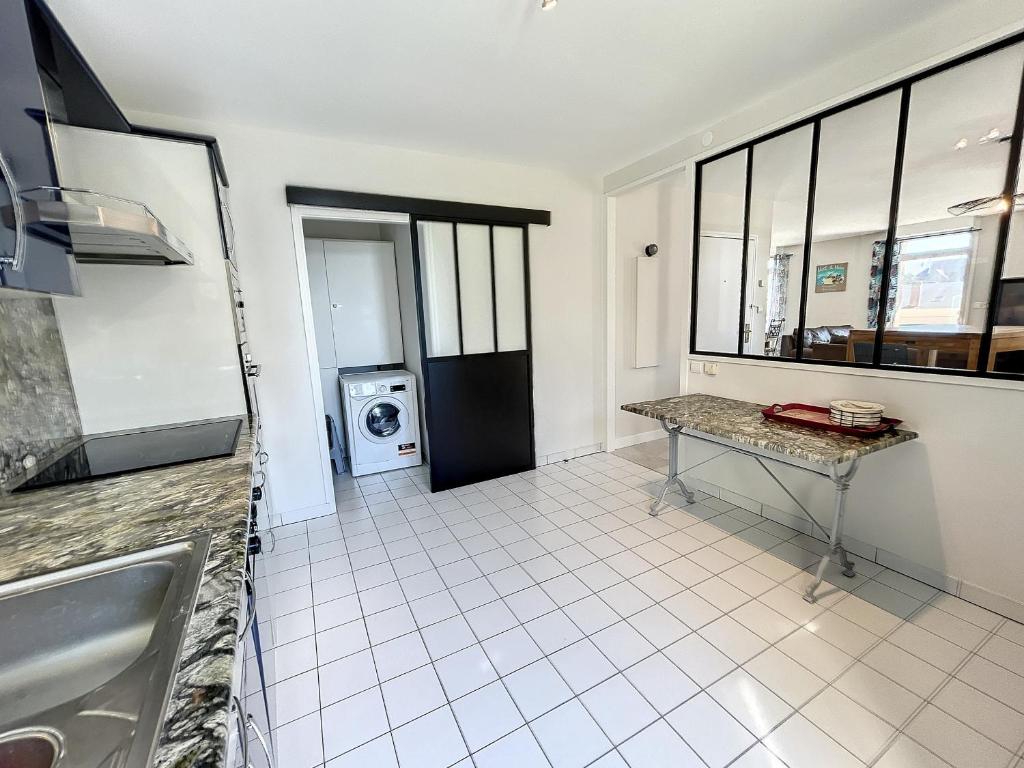 a kitchen with a sink and a tiled floor at Appartement Saint-Pair-sur-Mer, 3 pièces, 4 personnes - FR-1-361-506 in Saint-Pair-sur-Mer