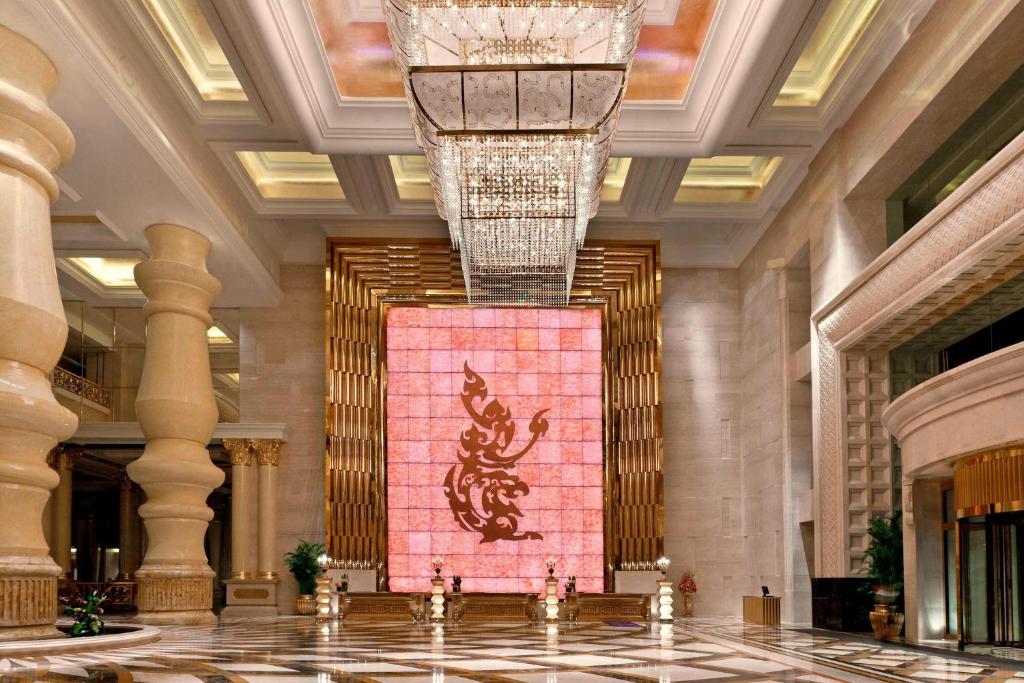 a lobby with a painting of a dragon on the wall at Sheraton Chongqing Hotel in Chongqing
