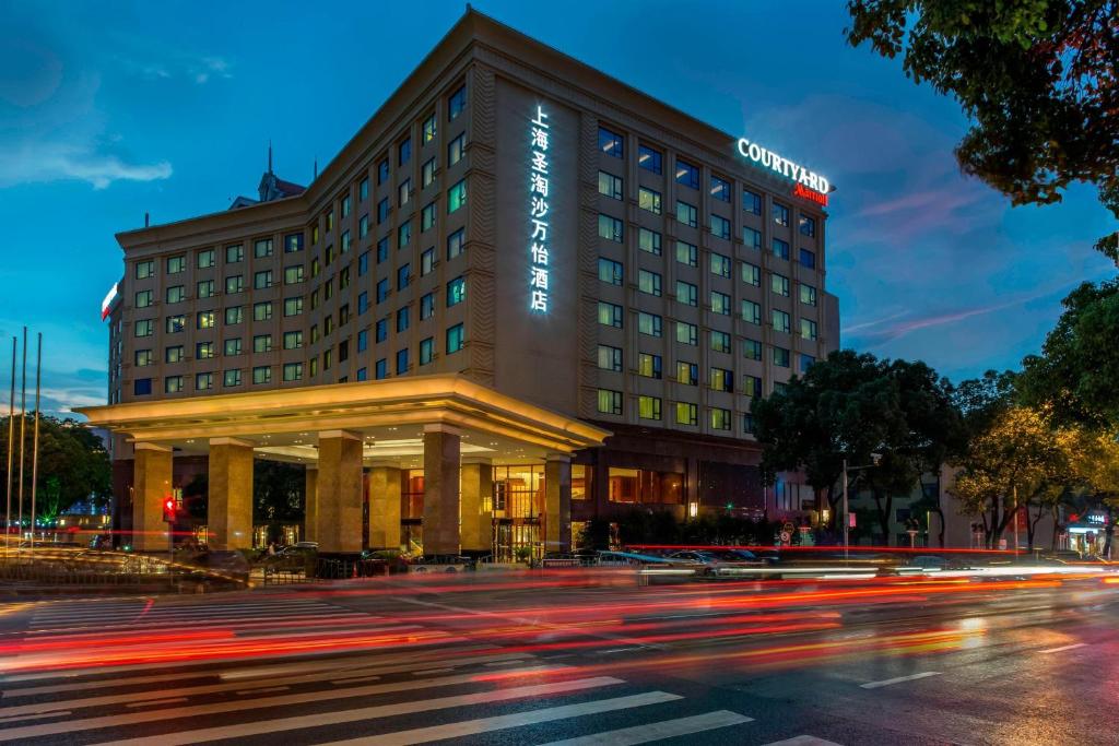 a building on a street with a street at Courtyard by Marriott Shanghai Fengxian in Fengxian