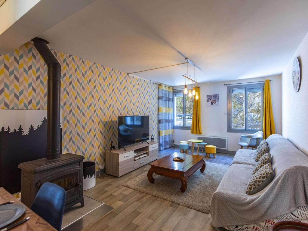 un salon avec un canapé et une télévision dans l'établissement Maison individuelle avec jardinet et salle de jeux - Cauterets - FR-1-401-271, à Cauterets