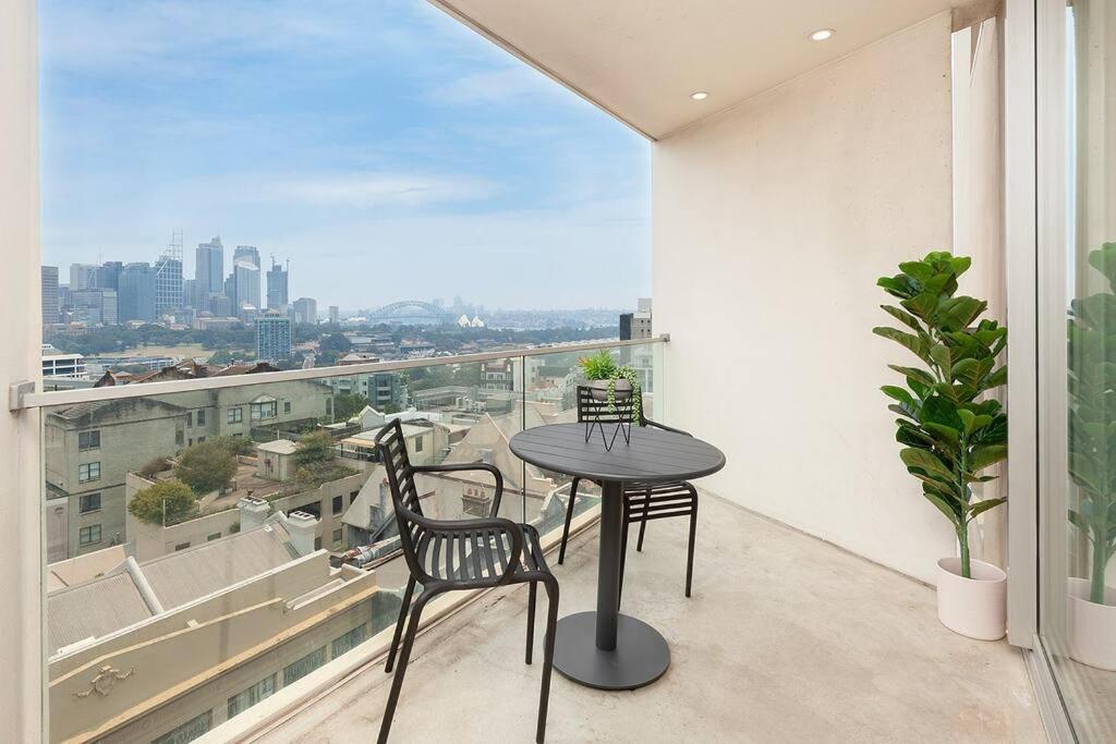 a table and chairs on a balcony with a view at DH707 - 1 bedroom unit Victoria St - Darlinghurst in Sydney