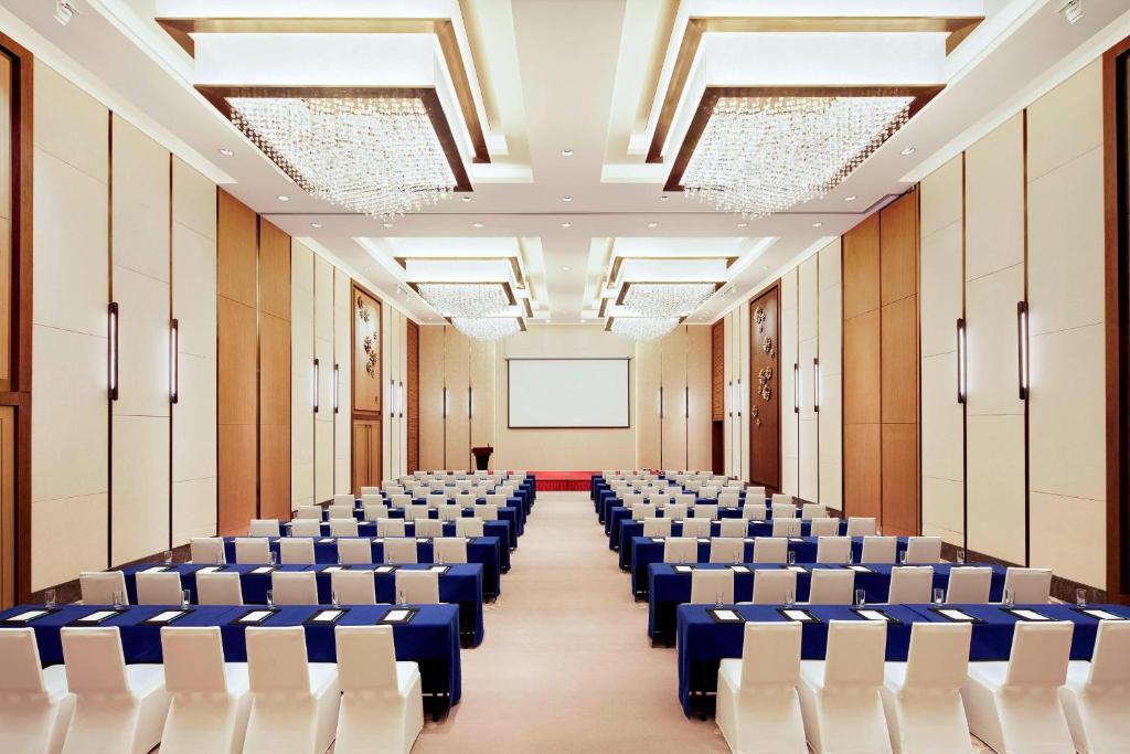 an empty room with rows of chairs and a screen at Four Points by Sheraton Changchun Hi-Tech Zone in Changchun