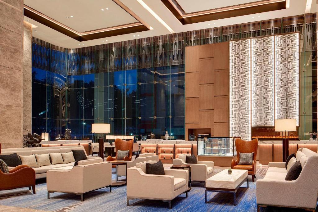 a lobby of a hotel with couches and chairs at Sheraton Zibo Hotel in Zibo
