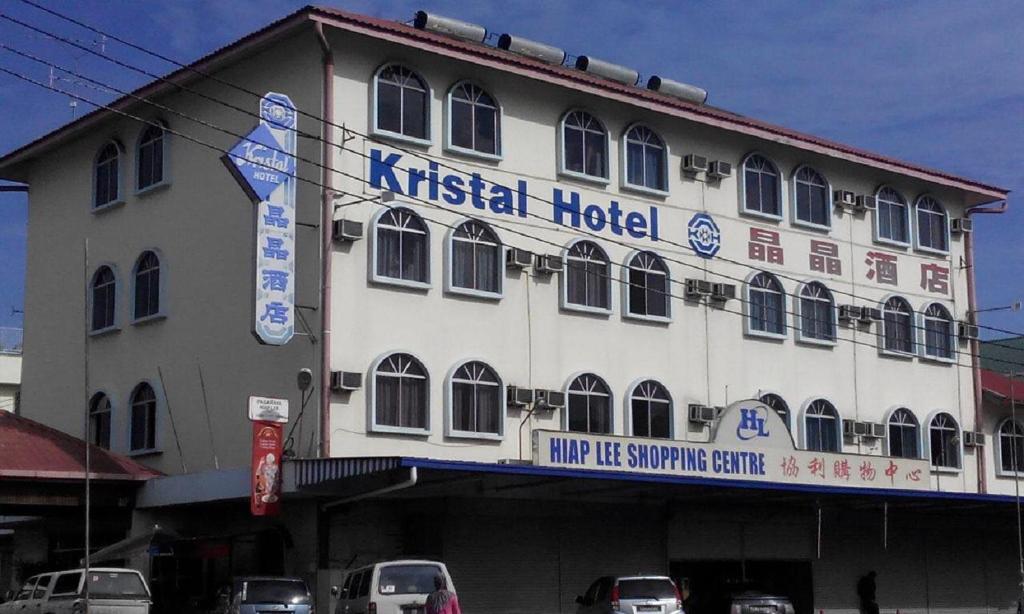 a building with akritiological hospital with cars parked in front of it at Hotel Kristal, Keningau in Keningau
