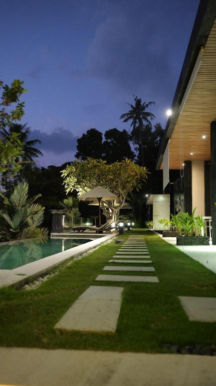 a walkway in front of a building at night at The Puncak Lombok in Senggigi