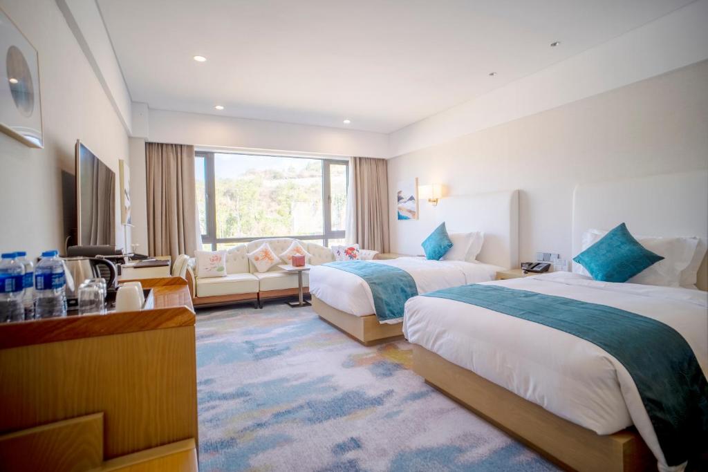 Postel nebo postele na pokoji v ubytování Hilton Lijiang
