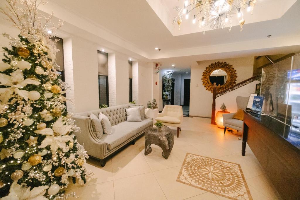 a christmas tree in the living room of a house at Sta Barbara Residence Hotel in Cebu City