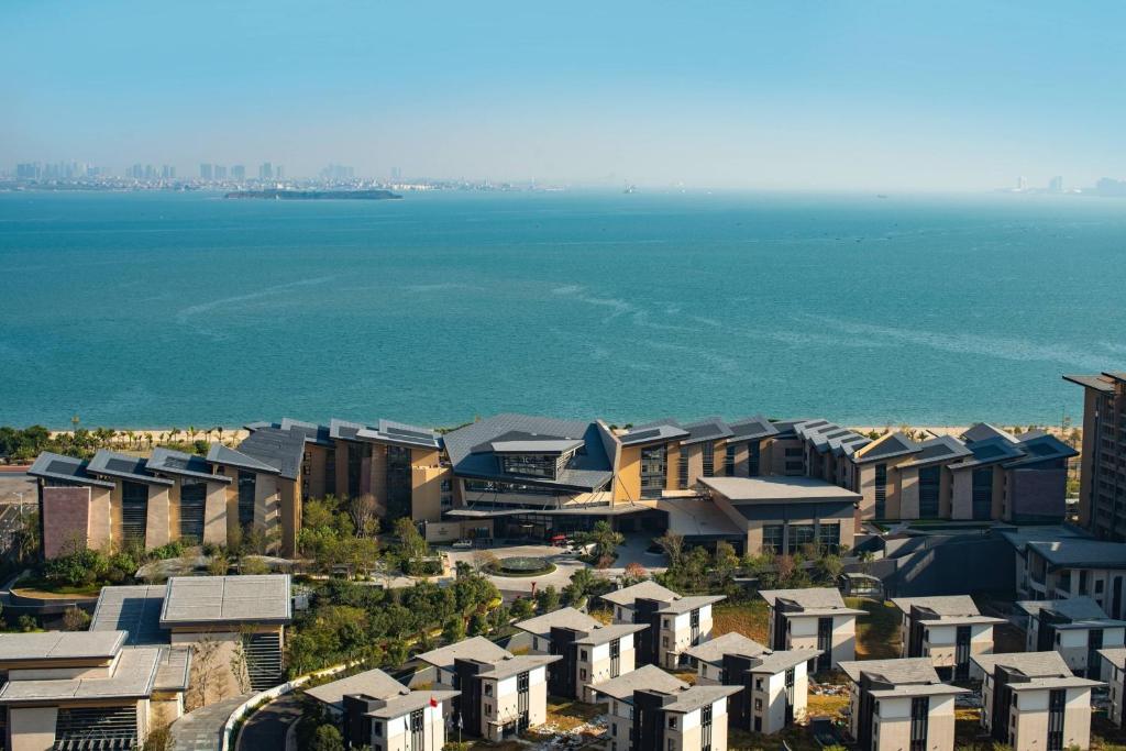 an aerial view of buildings next to the ocean at Renaissance Xiamen Hotel in Xiamen