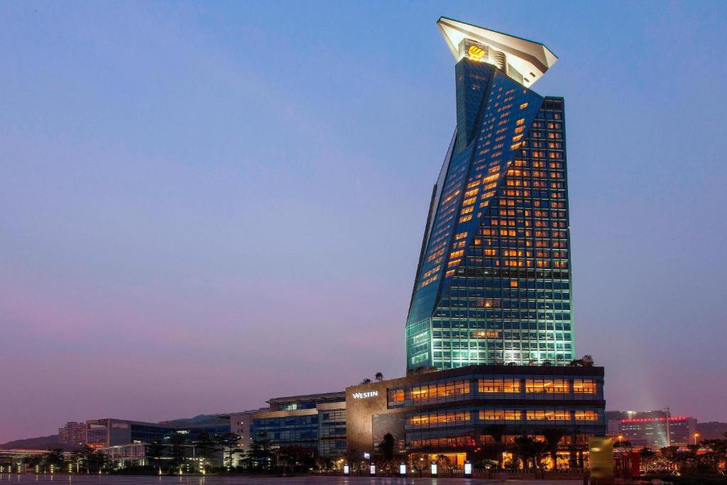 a tall building with its lights on at The Westin Xiamen in Xiamen