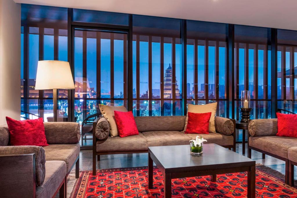 a living room with two couches and a table at The Westin Xi'an in Xi'an