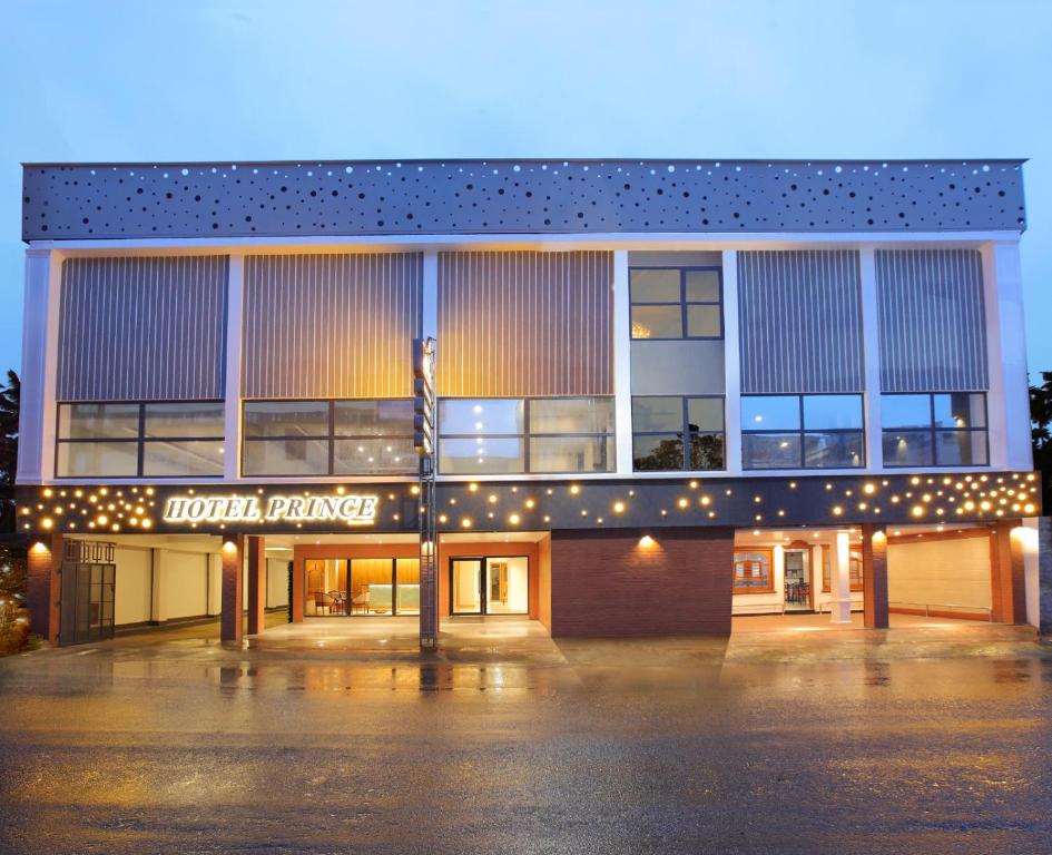 a building with a parking lot in front of it at HOTEL PRINCE in Kāladi