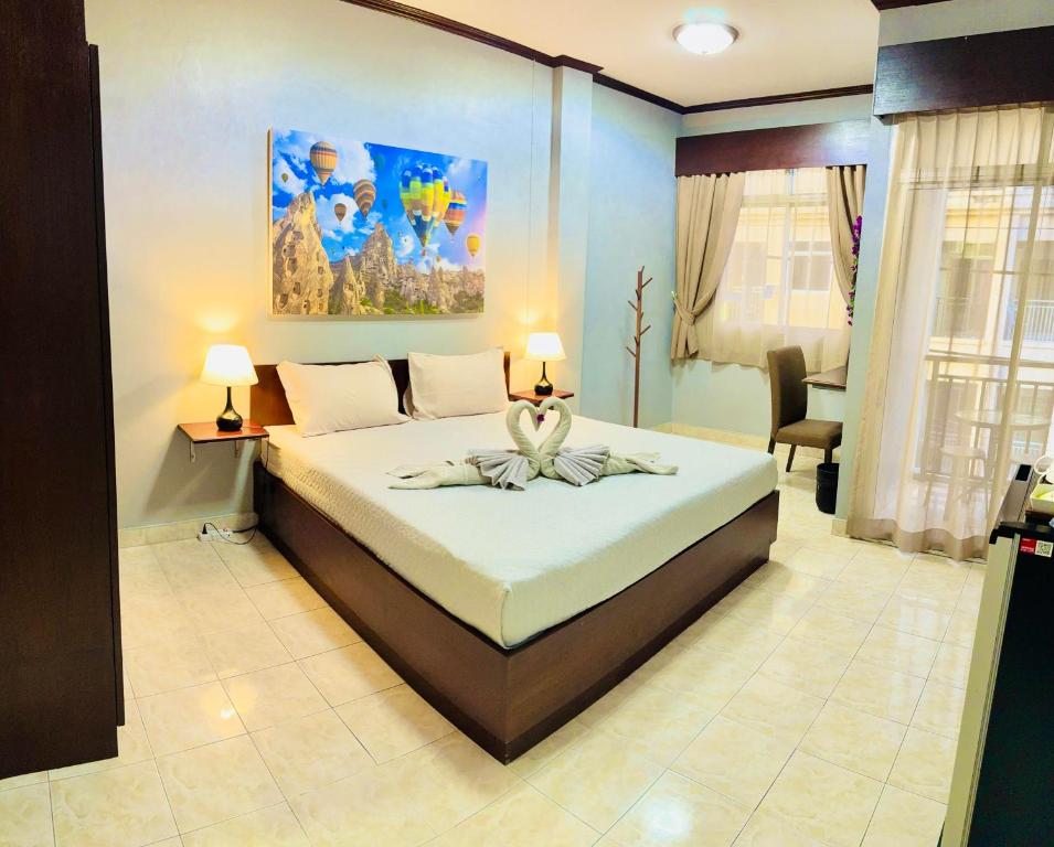 a bedroom with a large bed in a room at S a f e Residence Patong in Patong Beach