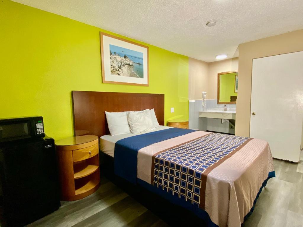 a hotel room with a bed and a sink at 4 Star Motel in Los Angeles